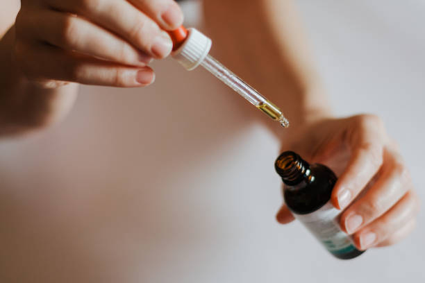 istock Woman's hands holding Ayurveda bottle with pipette 1192157817
