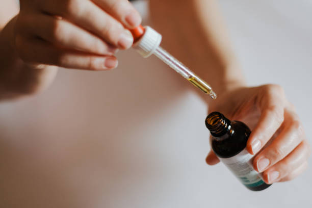 istock Woman's hands holding Ayurveda bottle with pipette 1192157865