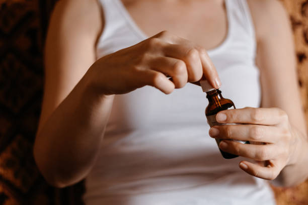 istock Woman holding Ayurveda bottle with pipette 1192157873