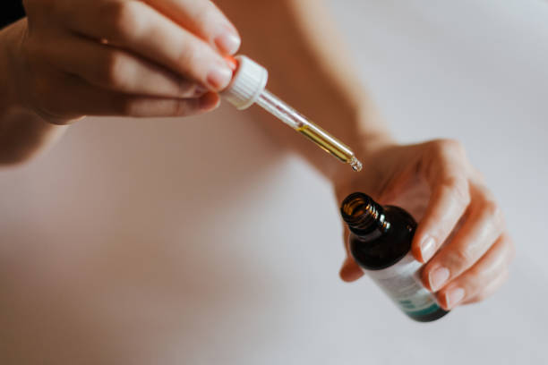 istock Woman's hands holding Ayurveda bottle with pipette 1192157908