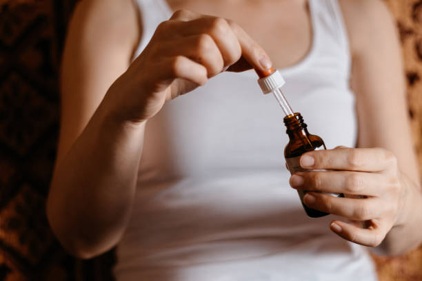 istock Woman holding Ayurveda bottle with pipette 1192157929
