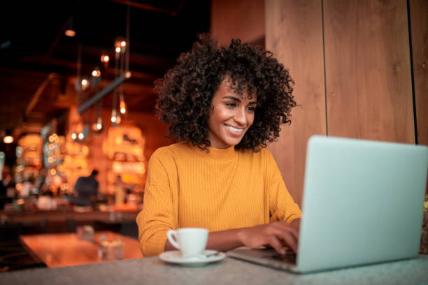 Online shopping Young woman sitting at a coffee shop and shopping online Happy Customer stock pictures, royalty-free photos & images