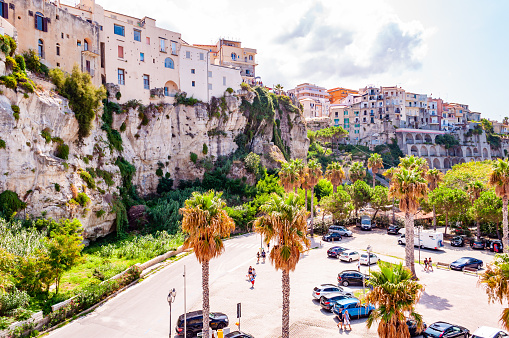 Tropea, Calabria, Italy - September 07, 2019: Famous sea promenade in Tropea with high cliffs with built on top city buildings and apartments. Parking area on the street. Amazing Italian cityscape