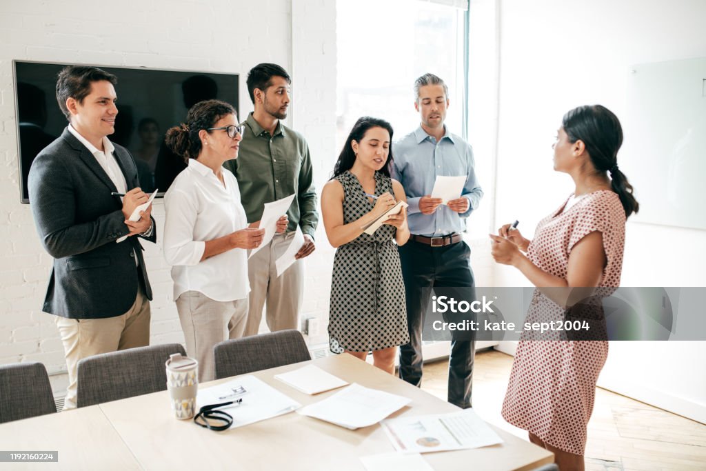 Training for business professionals Group of people in front of a mentor Occupation Stock Photo