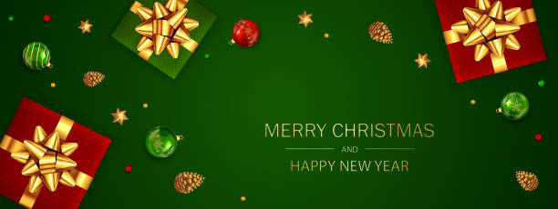 istock Gift Box with Golden Holiday Bow and Christmas Balls on Green Baclground 1192162381