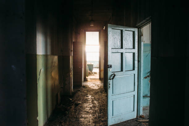 istock Dirty corridor in abandoned building, scary atmosphere with light in end 1192162843