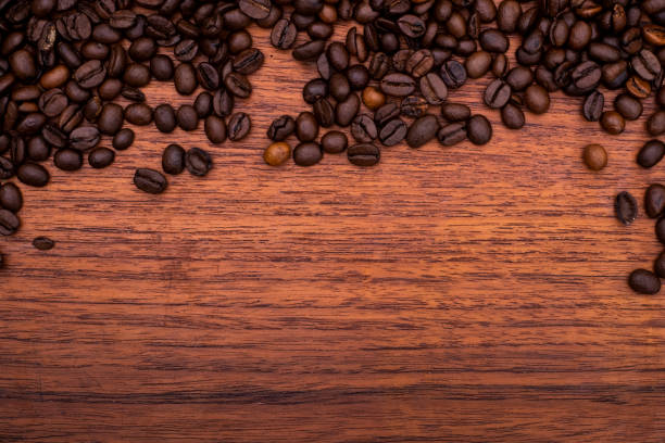 istock Coffee beans on wooden texture background 1192163790