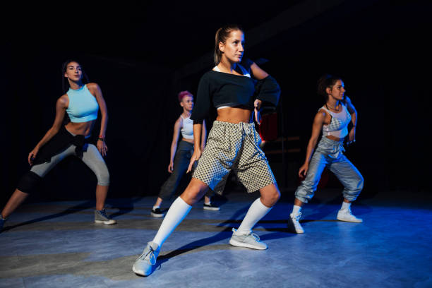 Just keep moving Group of young caucasian dancers practicing their performance at the dance studio dance troupe stock pictures, royalty-free photos & images