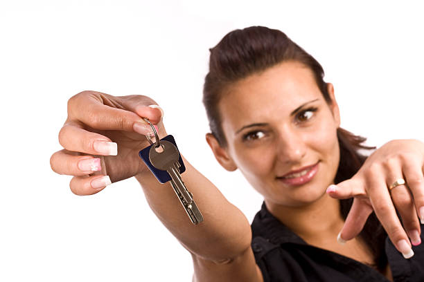 istock woman showing key 119216547