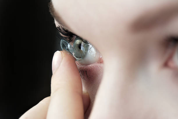 girl holding soft contact lenses stock photo