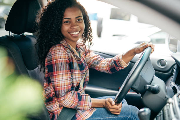 A teenager driving a car