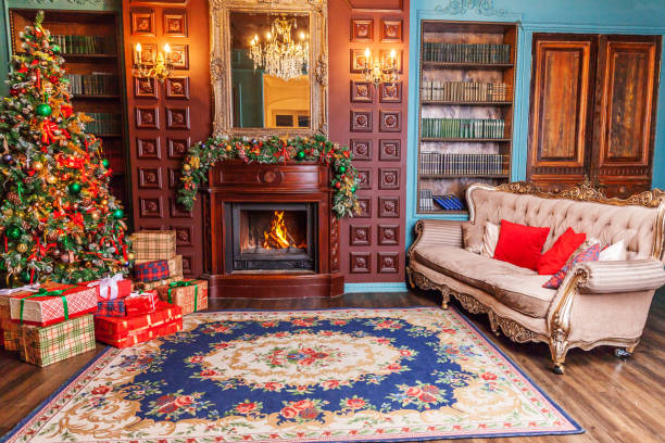 istock Classic Christmas New Year decorated interior room home library with fireplace. Christmas tree with red ornament decorations. Modern classical style interior design apartment. Christmas eve at home 1192168262