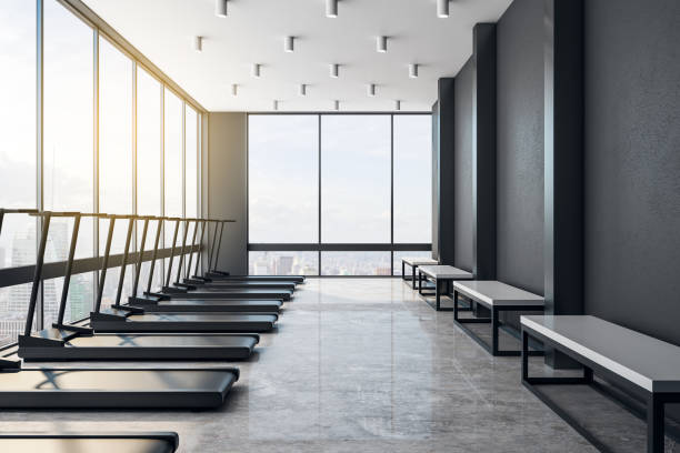 istock Modern light loft style gym interior with black treadmiils. 1192170699