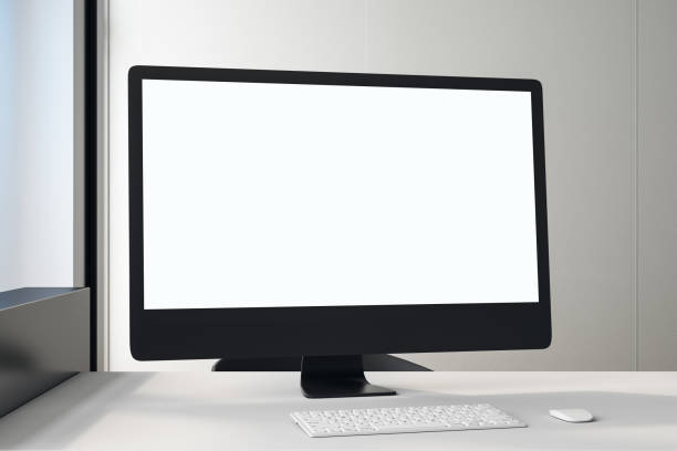 istock White blank screen of black computer monitor on white table in light office. 1192170781
