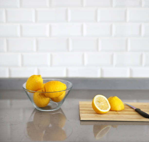 istock Bowl with lemons on a wooden  board for cutting 1192170911