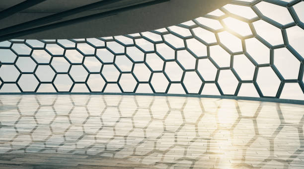 istock Futuristic style empty hall with honeycomb window and wooden floor at sunset. 1192170973