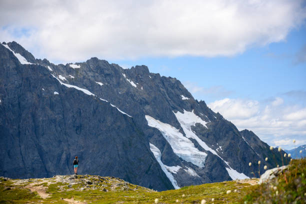 istock Hiker Stands At The Edge of Ridge 1192173643