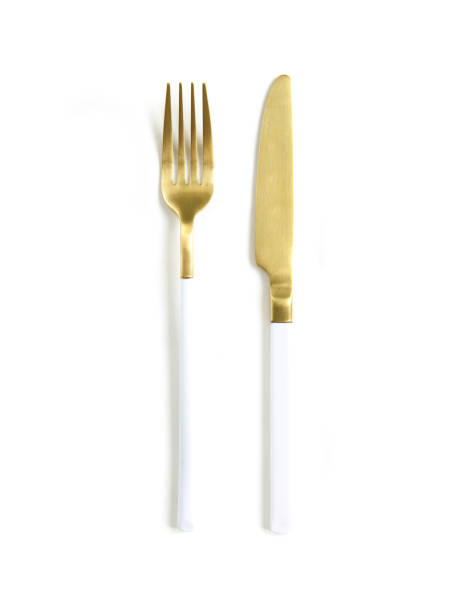 istock White golden cutlery view from above on a white background. Top view.Knife and fork for a festive table for a wedding, birthday or party. 1192175447