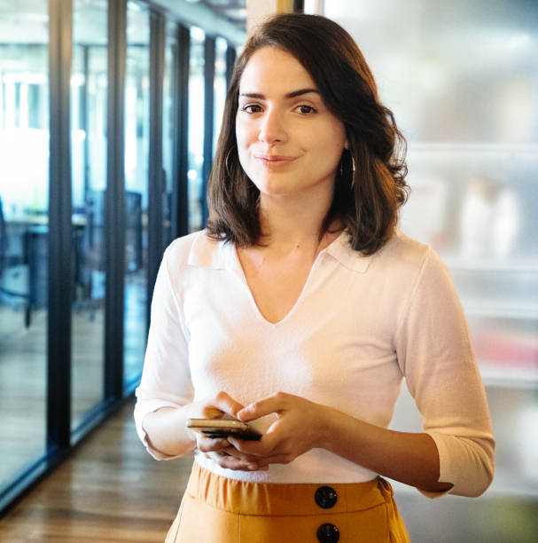 istock Confident young professional portrait in office with a mobile phone 1192177117
