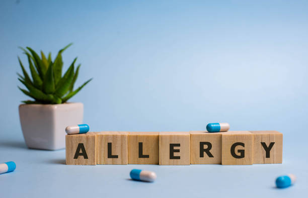istock wooden cubes with word Allergy on blue backgound 1192177701