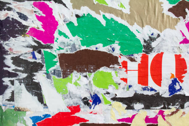 istock Old dirty torn and peeling paper posters and placards on the wall texture background. 1192177918