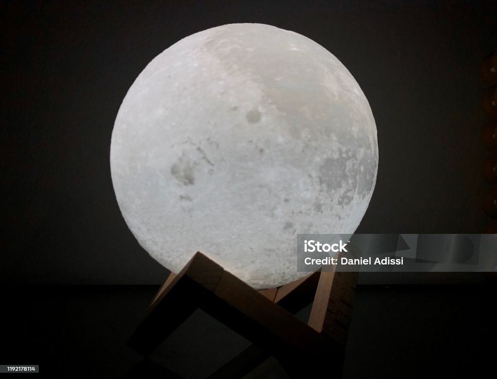 Moon Lamp Moon lamp bright night light with astonishing design laying on top of a symmetric shape. Children's Nightlight Stock Photo