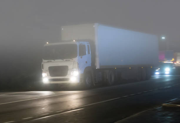 istock truck is moving on the highway at night 1192178171