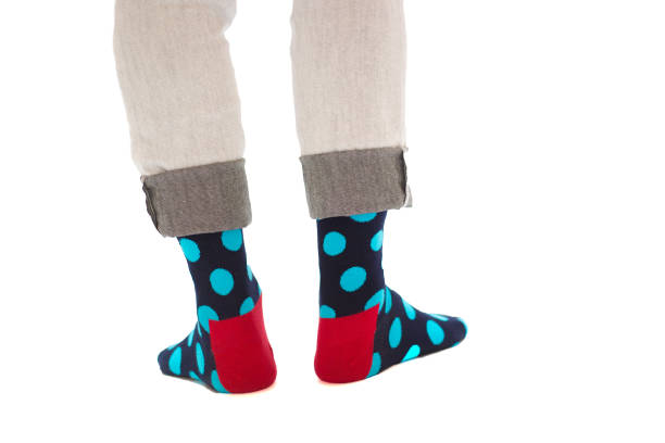 istock Man's Feet in Funny Polka-Dot Socks, White Background 1192182867
