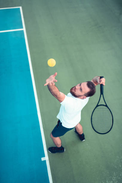 istock Male Tennis Player Serving 1192185570