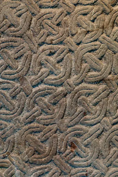 Photo of Celtic carved stone pattern intricate and repetitive