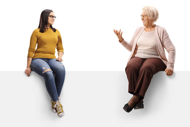 istock Young and senior woman sitting on a panel and having a conversation 1192194111