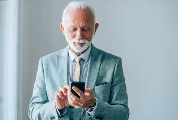 istock Senior businessman texting in the office. 1192195175