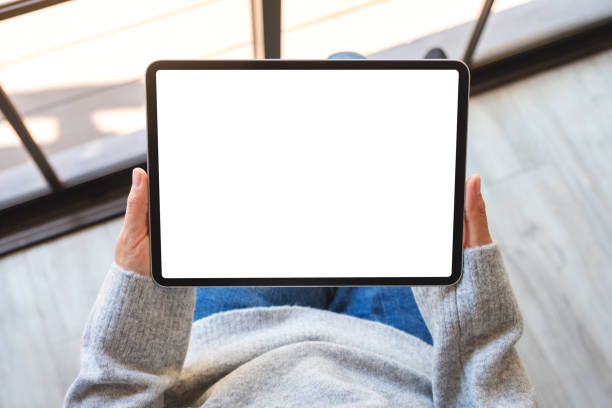 istock a woman holding black tablet pc with blank white screen 1192196827