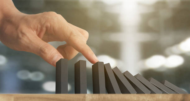 istock Hand stopping  Domino effect stopped by unique 1192197817