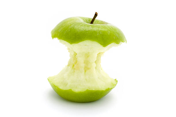 green apple core over white  apple with bite out stock pictures, royalty-free photos & images
