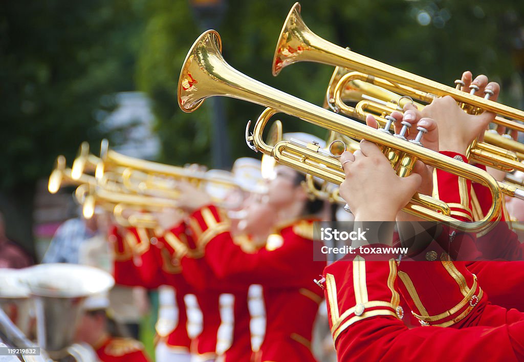 Brass band of girls playing their instruments together Girl Brass Band in red uniform performing Parade Stock Photo