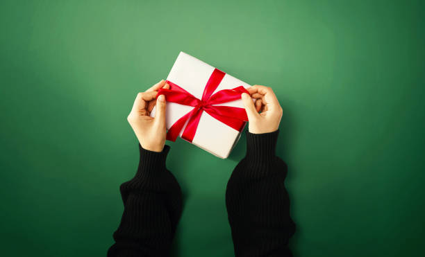 istock Person holding a gift box 1192200216