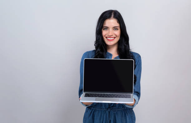 istock Young woman with a laptop computer 1192203159