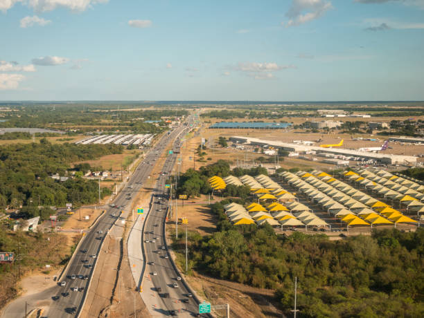 View of Parking Lot Businesses next to the Austin International Airport in Clear sunny day Austin, Texas: September 2019: View of Parking Lot Businesses next to the Austin International Airport in Clear Sunny day austin airport stock pictures, royalty-free photos & images