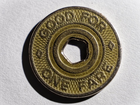 Close-up of a New York City subway token in color landscape format