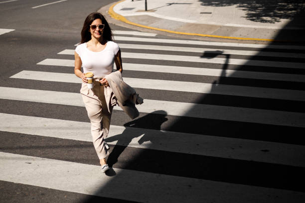 istock Woman walking on pedestrian crossing line 1192208670
