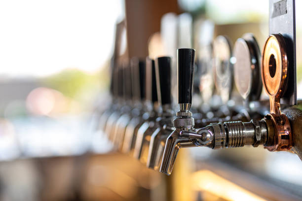 Beer Taps In Rooftop Bar Beer Taps In Rooftop Bar With High Key Background And Copy Space microbrewery photos stock pictures, royalty-free photos & images