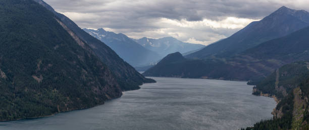 Interior of British Columbia, Canada Aerial View of Anderson Lake surrounded by Canadian Mountain Landscape during a cloudy summer day. Located near Lillooet, BC, Canada. pemberton town stock pictures, royalty-free photos & images