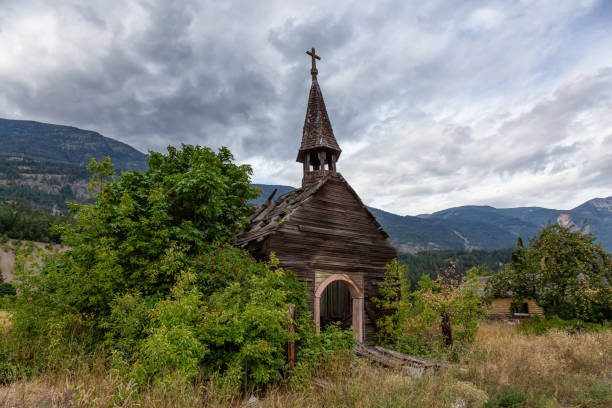 Interior British Columbia, Canada Old Abandoned catholic church in a small remote town, Seton Portage, during a cloudy summer day. Located near Lillooet and Pemberton, BC, Canada. pemberton town stock pictures, royalty-free photos & images