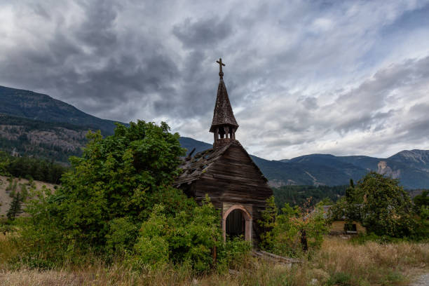 Interior British Columbia, Canada Old Abandoned catholic church in a small remote town, Seton Portage, during a cloudy summer day. Located near Lillooet and Pemberton, BC, Canada. pemberton town stock pictures, royalty-free photos & images