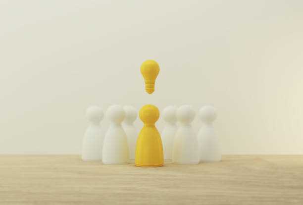 istock Outstanding yellow people standing with light bulb icon out from the crowd. Human resource, Talent management, Recruitment employee, Successful business team leader concept. 1192217974