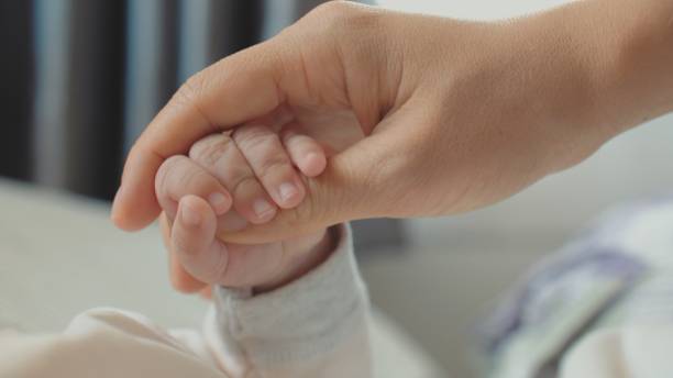 istock CU : Mother holding her baby hand 1192218856
