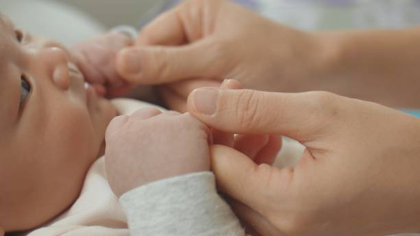 istock CU : Mother holding her baby hand 1192218862