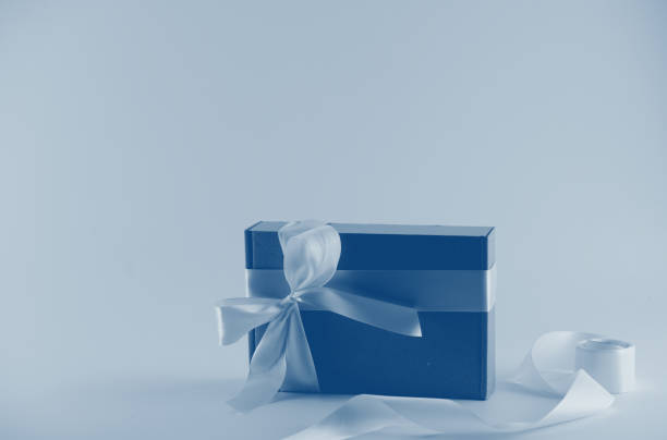 istock Gift box with a blue ribbon in neon light with a blue tint 1192221806