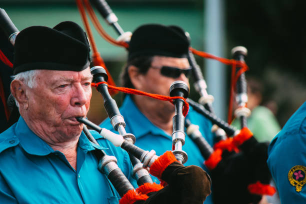 Close-up of Scottish Highland Bagpipe from the Noosa and District Pipe Band players marching during ANZAC Day service in Cooroy, near Noosa in Queensland Close-up image two Bagpipe players wearing traditional Scottish Highland marching uniform of the Noosa & District Pipe Band. glengarry cap stock pictures, royalty-free photos & images